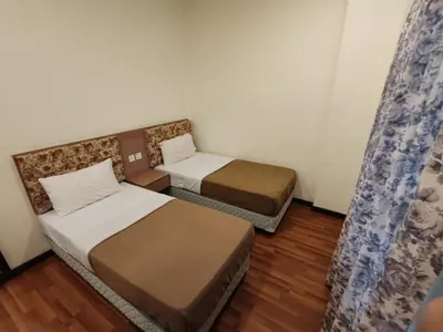 a room with two beds and a window at Iris House Resort & Apartment Cameron Highlands in Cameron Highlands