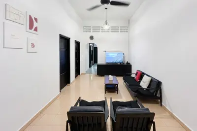 a living room with couches and a table at Homestay Taman Canning Ipoh, Perak - Smarthome in Ipoh