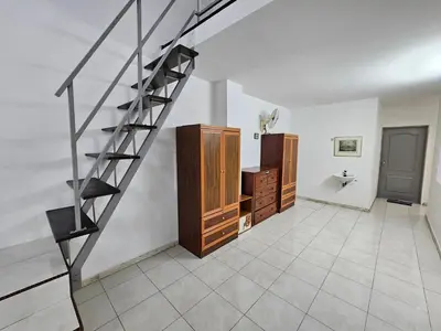 a staircase in a room with a tiled floor at Rain Forest Hostel in Ipoh