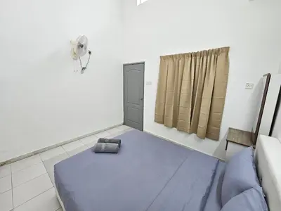 a bedroom with a blue bed and a window at Rain Forest Hostel in Ipoh