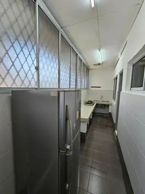 a kitchen with a stainless steel refrigerator and a sink at Rain Forest Hostel in Ipoh
