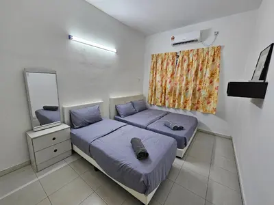 a small bedroom with two beds and a mirror at Rain Forest Hostel in Ipoh