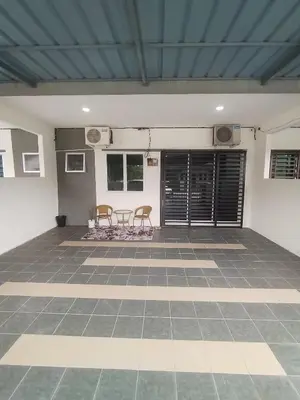 a room with two chairs and a table on a tiled floor at Ed 01 sitiawan homestay in Sitiawan