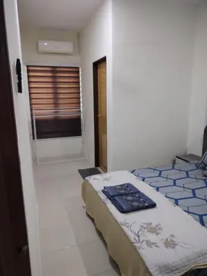 a bedroom with two beds in a room with a window at Ed 01 sitiawan homestay in Sitiawan