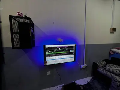 a tv on a wall with a blue light at Homestay Seri Aishah in Chemor