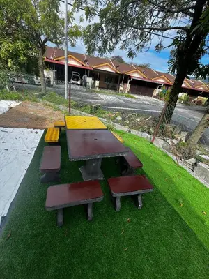 a group of picnic tables on the grass at Homestay Seri Aishah in Chemor
