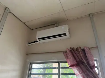 a air conditioner in a room with a window at Homestay Seri Aishah in Chemor