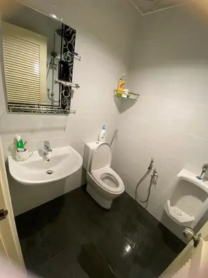 a bathroom with a toilet and a sink at Lisa Countryside Homestay in Ayer Tawar