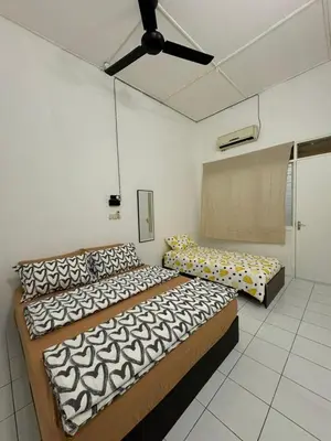 a bedroom with two beds and a ceiling fan at Yipstay Gopeng HomeTown in Gopeng