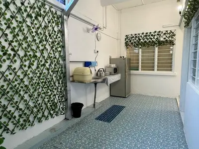 a small kitchen with a counter and a refrigerator at Yipstay Gopeng HomeTown in Gopeng
