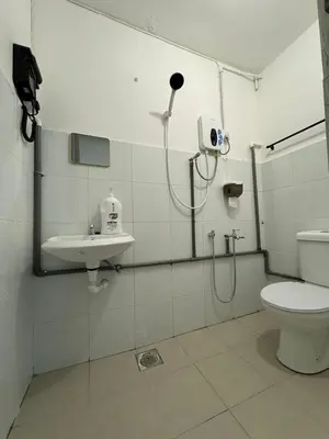 a bathroom with a shower and a toilet and a sink at Yipstay Gopeng HomeTown in Gopeng