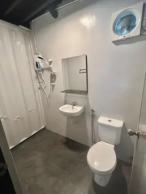 a bathroom with a white toilet and a sink at The Cozytainer in Taiping