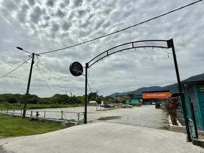 an arch over a road in front of a building at The Cozytainer in Taiping