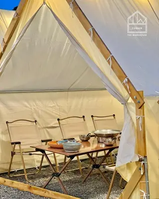 a tent with a table and chairs in it at The Cozytainer in Taiping