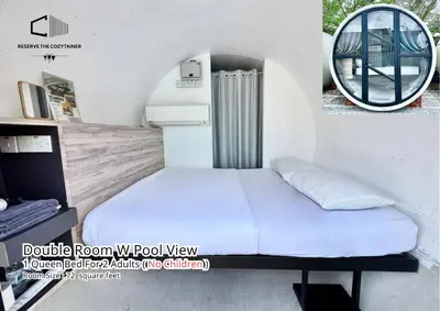 a bedroom with a bed and a round mirror at The Cozytainer in Taiping