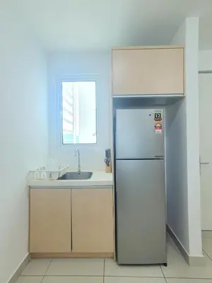 a kitchen with a refrigerator and a sink at Southbay Seaview Condo A23 #10minQueensbay in Bayan Lepas