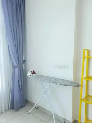 a table in a room with a blue curtain at Southbay Seaview Condo A23 #10minQueensbay in Bayan Lepas