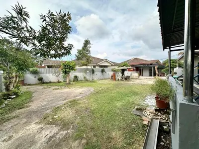 a yard of a house with a fence at Homestay Mohd Lee in Sungai Petani