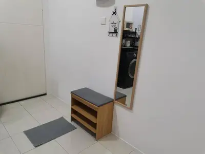 a mirror and a stool in a room at myuu homestay in Ipoh