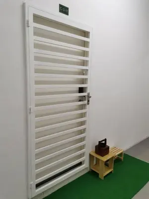 a large white garage door with a wooden table at myuu homestay in Ipoh