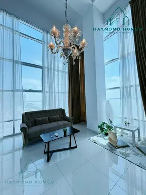 a living room with a couch and a chandelier at Maritime Sea View Duplex in George Town