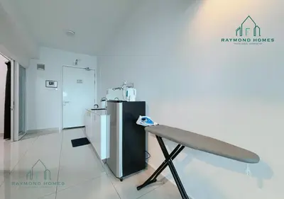 a white room with a counter and a refrigerator at Maritime Sea View Duplex in George Town