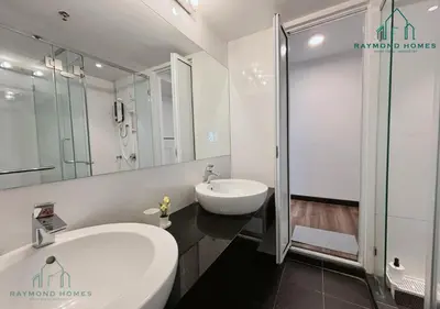 a white bathroom with a sink and a shower at Maritime Sea View Duplex in George Town