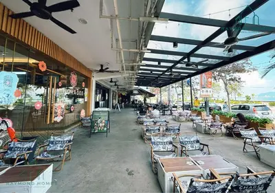 an outdoor patio with chairs and tables and a building at Maritime Sea View Duplex in George Town
