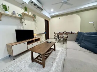 a living room with a couch and a tv and a table at NEW-Serene Home Juru Sentral Icon City in Bukit Mertajam