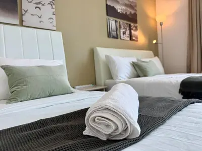 a hotel room with two beds with towels on them at NEW-Serene Home Juru Sentral Icon City in Bukit Mertajam