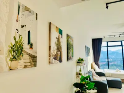 a living room with paintings on the wall at 2BR Georgetown Luxury Suite #RooftopPool #Beacon in George Town