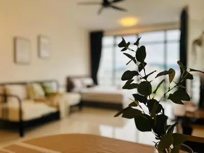 a living room with a plant in a vase on a table at Comfy 2BR Sunny Suite Sky Pool & Stunning Views in George Town