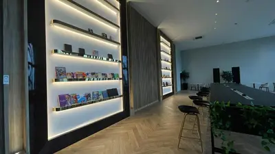 a room with shelves of books on the wall at Comfy 2BR Sunny Suite Sky Pool & Stunning Views in George Town