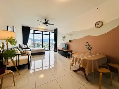 a living room with a bed and a table in it at Comfy 2BR Sunny Suite Sky Pool & Stunning Views in George Town