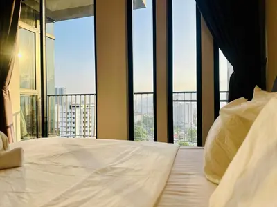 a bedroom with a large white bed with large windows at Elegant 2BR Luxury Suite in Haaven in George Town
