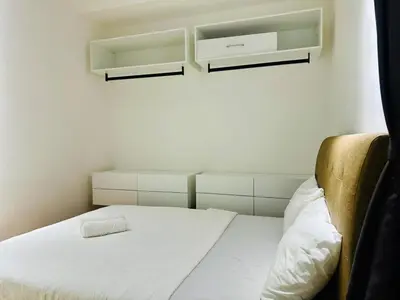 a bedroom with a white bed and two white shelves at Elegant 2BR Luxury Suite in Haaven in George Town