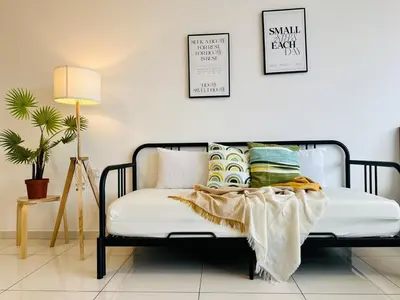 a bedroom with a bed with pillows on it at Fresh, Modern Georgetown Suite with Sky Pool Views in George Town