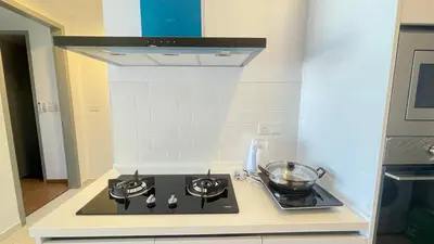a kitchen with a stove with a bowl on it at Fresh, Modern Georgetown Suite with Sky Pool Views in George Town