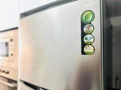 a refrigerator with a bunch of magnets on it at Fresh, Modern Georgetown Suite with Sky Pool Views in George Town