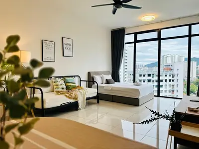 a living room with two beds and a large window at Fresh, Modern Georgetown Suite with Sky Pool Views in George Town
