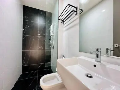 a white bathroom with a sink and a toilet at Luxury 2BR SunnySuite Sky Pool Breathtaking Views in George Town