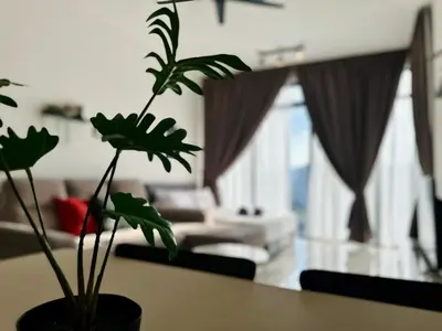a living room with a table with a plant on it at Luxury 2BR SunnySuite Sky Pool Breathtaking Views in George Town