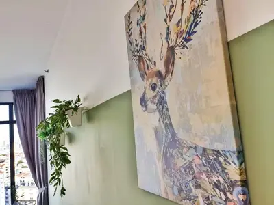 a painting of a deer hanging on a wall at Luxury Sky Pool 8-Pax City Centre Beacon in George Town