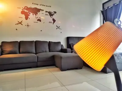 a living room with a couch and a map of the world at Luxury Sky Pool 8-Pax City Centre Beacon in George Town