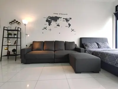 a living room with a couch and a world map on the wall at Luxury Sky Pool 8-Pax City Centre Beacon in George Town