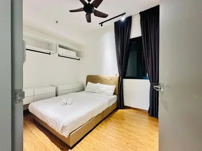 a bedroom with a bed and a ceiling fan at Spacious 2BR Suite for 5-7 pax in George Town