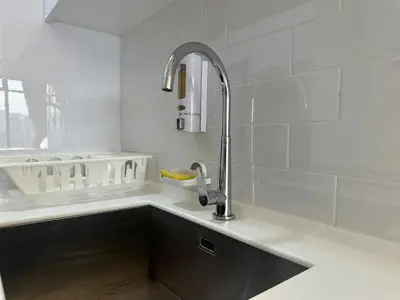 a kitchen with a sink and a faucet at Spacious 2BR Suite for 5-7 pax in George Town