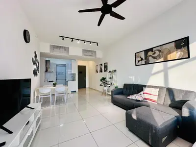 a living room with a couch and a ceiling fan at Spacious 2BR Suite for 5-7 pax in George Town
