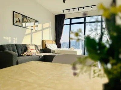 a living room with a couch and a large window at Spacious 2BR Suite for 5-7 pax in George Town