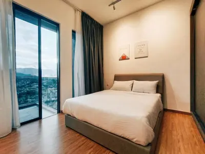 a bedroom with a bed and a large window at Stunning 2BR with Infinity Pool & City Views in George Town